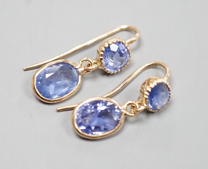 A pair of 14k yellow metal and two stone sapphire set drop earrings, 23mm, gross weight 2.4 grams.